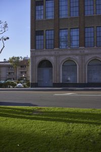 an image of a fire hydrant sitting in the grass outside of an apartment complex