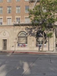 an older building with windows on a side street in the city with no traffic at all