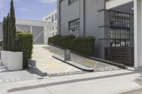 a couple of concrete planters sit in front of an office building on a street