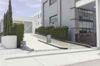 a couple of concrete planters sit in front of an office building on a street