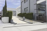a couple of concrete planters sit in front of an office building on a street