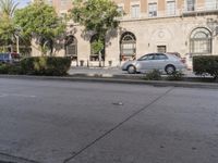 an older man riding a skateboard down the street from another person, while others look on