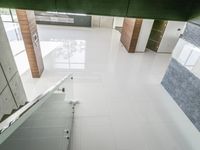 view from above a toilet cubicl with tiled floors and stalls in an open room