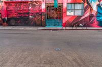 a fire hydrant on the side of a road with red graffiti painted all over it