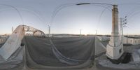 a fish eye view of the streets at a bridge with no traffic or crossing sign