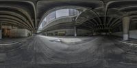 a view through a fish eye lens of the street below a bridge over a street