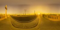 an image of the view from a fish eye lens at sunset through the top half of a bridge