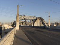 a bridge with an overpass crossing it over the street with buildings in the background