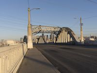 a bridge with an overpass crossing it over the street with buildings in the background