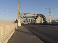 a bridge with an overpass crossing it over the street with buildings in the background