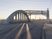 a view of a bridge on a highway in front of a city light at sunset