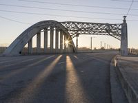 a view of a bridge on a highway in front of a city light at sunset