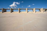 the concrete structure is all over with some clouds in the sky behind it and below it