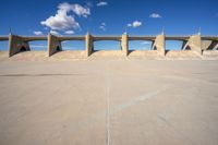 the concrete structure is all over with some clouds in the sky behind it and below it