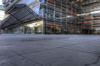 a building that is very large and empty with concrete floors, some windows and glass