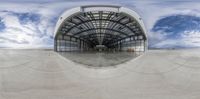 an outdoor structure with a sky background and a skateboard in the foreground,