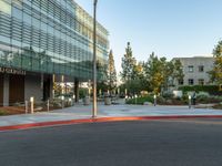 two grey blocks sitting next to a tall building on a sidewalk in front of grass