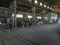 industrial area in a building with machinery for repairs on the floor and steel equipment and windows