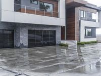 a building with two garage doors on each side and some windows on the second story