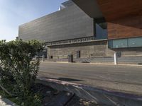 an image of the exterior of the building on a sunny day, featuring stairs and plants