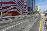 a person is riding a bike on a city street in front of an american flag