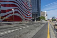 a person is riding a bike on a city street in front of an american flag