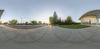 a fisheye lens showing two guys doing tricks in the air while on a skateboard