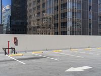 a parking lot is shown with two barriers and a street sign with the corner of it