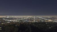 a view of los at night with light trail running between city lights on hillsides
