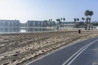 the beach and boardwalk at a resort by the water is empty on a clear day