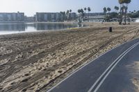 the beach and boardwalk at a resort by the water is empty on a clear day