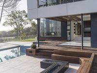 a pool that's reflecting the landscape with trees and shrubs surrounding it is very modern