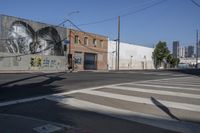 an empty road and a wall with graffiti on it in the city of los angeles, california