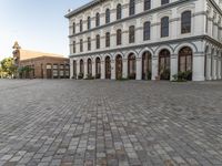 a large building has windows that open onto a courtyard with several smaller windows and doors