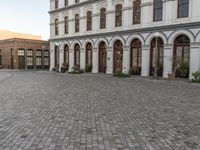 a large building has windows that open onto a courtyard with several smaller windows and doors