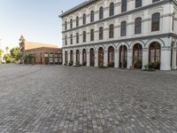 a large building has windows that open onto a courtyard with several smaller windows and doors