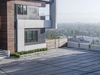 the exterior and landscape of a modern house in los angeles, california with stone and wood