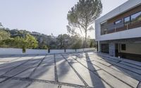 the exterior and landscape of a modern house in los angeles, california with stone and wood