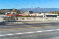 this is the city in california from on an overpass over the road, overlooking a mountainous city