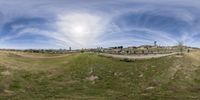 a panorama of the grass and hills is shown in this 360 - fish eye photograph