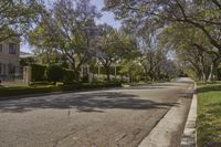 trees line the street in front of an apartment building in beverly hills, california, where police officers search homes and cars