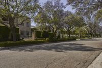 trees line the street in front of an apartment building in beverly hills, california, where police officers search homes and cars