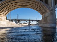 the view of an over pass as it passes underneath an overpass bridge in california