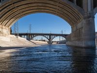 the view of an over pass as it passes underneath an overpass bridge in california