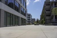 a city square has several different sized buildings and landscaping in them with glass panels along the walkway