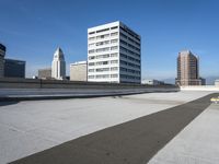 the roof of a very large building with city in background in a business district district