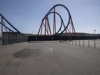 the roller coaster on display sits in an empty parking lot outside of the amusement park