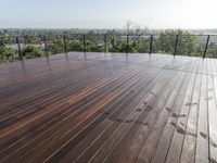 a wooden deck overlooks the trees and sky in this image is shown from the outside