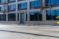 a sign in front of a commercial building on an open road with a sign pointing out the windows and there are no people