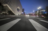 a view of traffic on an empty city street at night, as seen from a car